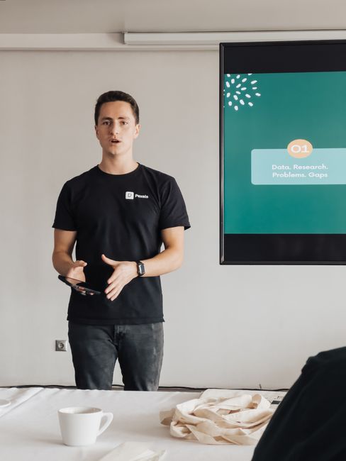 AI researchers presenting a paper at an academic conference on open-source models