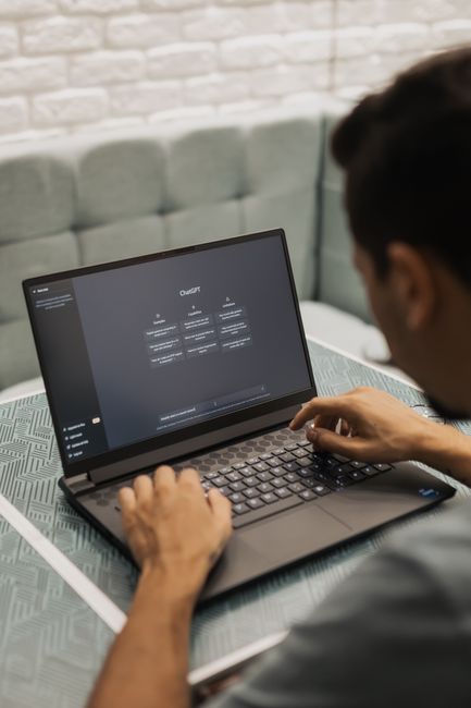 Person using Microsoft Copilot AI assistant on a laptop
