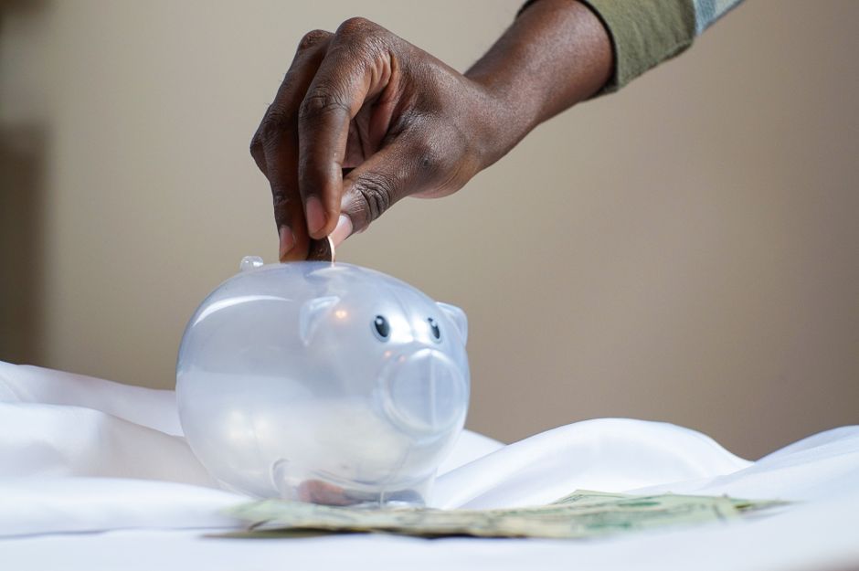 Piggy bank with coins representing cost savings in technology