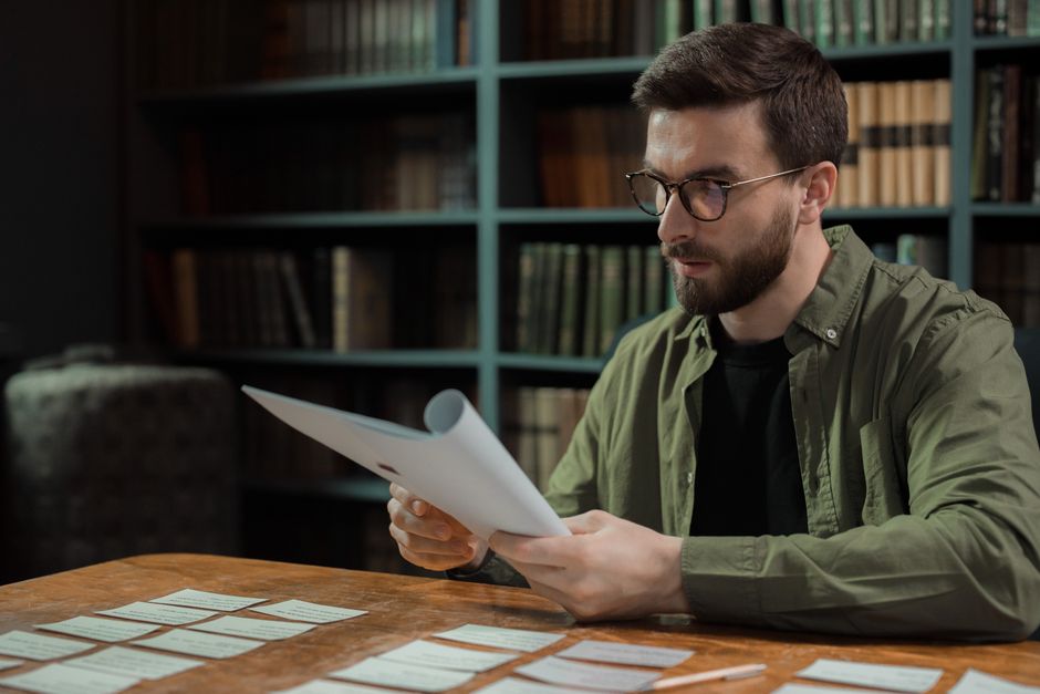 Researcher analyzing large volumes of documents using AI assistance at a desk