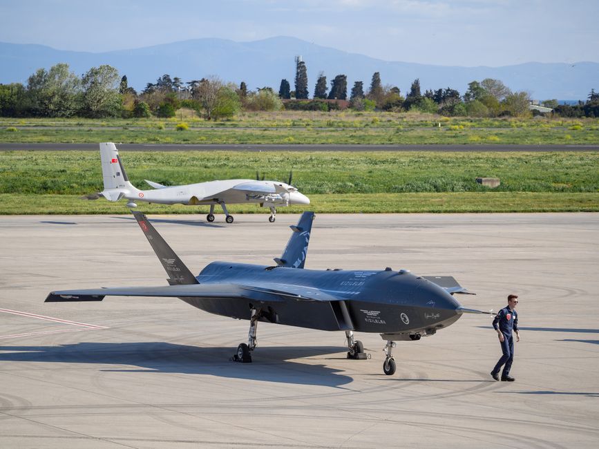 Multiple military drones flying in formation