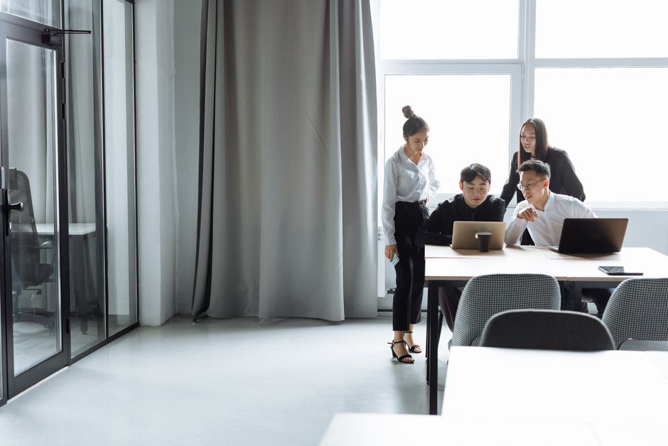 Business team collaborating with AI tools in a corporate office
