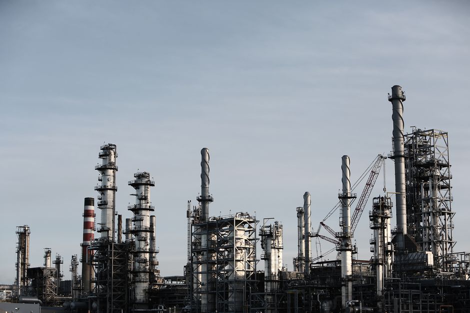 Large oil refinery with smoke stacks at dusk