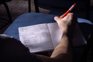 Person taking notes in a notebook