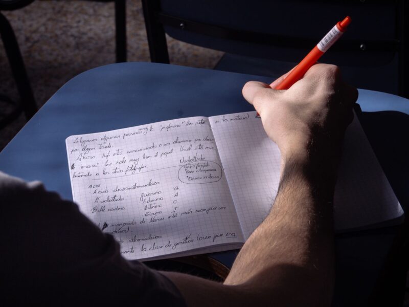 Person taking notes in a notebook