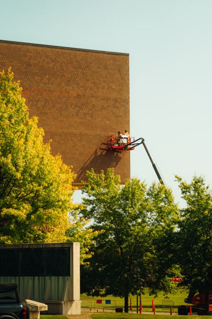 Workers performing maintenance on an outdoor public monument