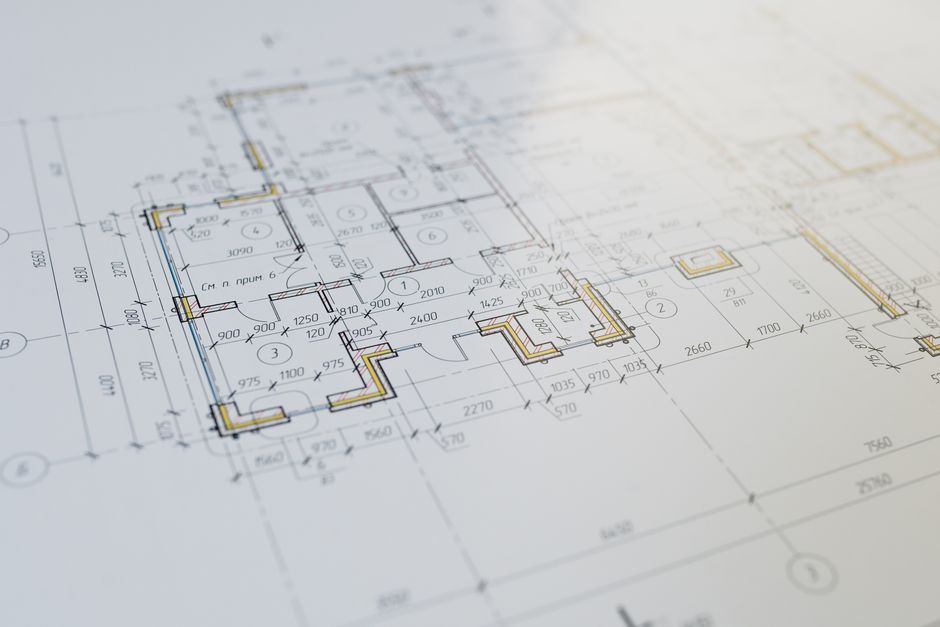 Engineers reviewing blueprints for a large infrastructure project