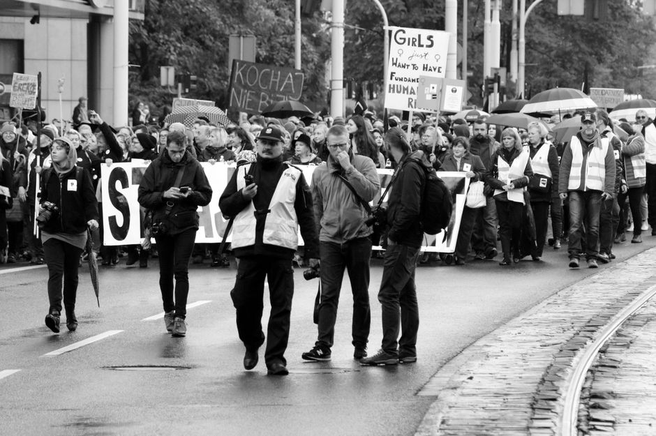 Protesters holding signs at a human rights demonstration