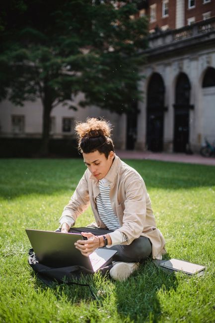 University student using AI chatbot on a laptop on campus