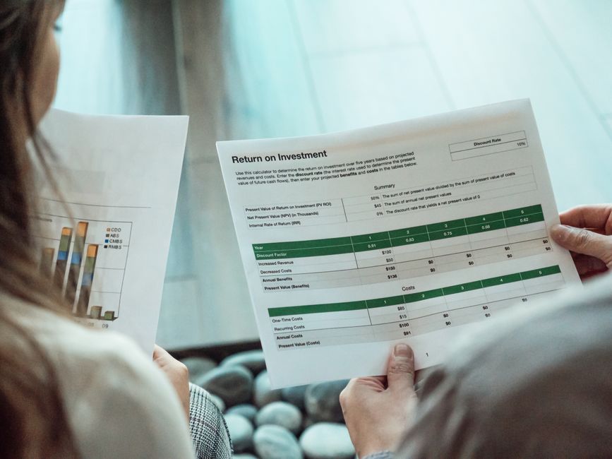 Calculator and financial analysis showing ROI calculation for premium AI subscription