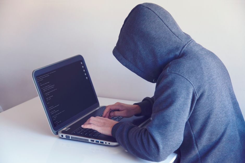 Hacker exploiting a zero-day vulnerability shown on multiple screens