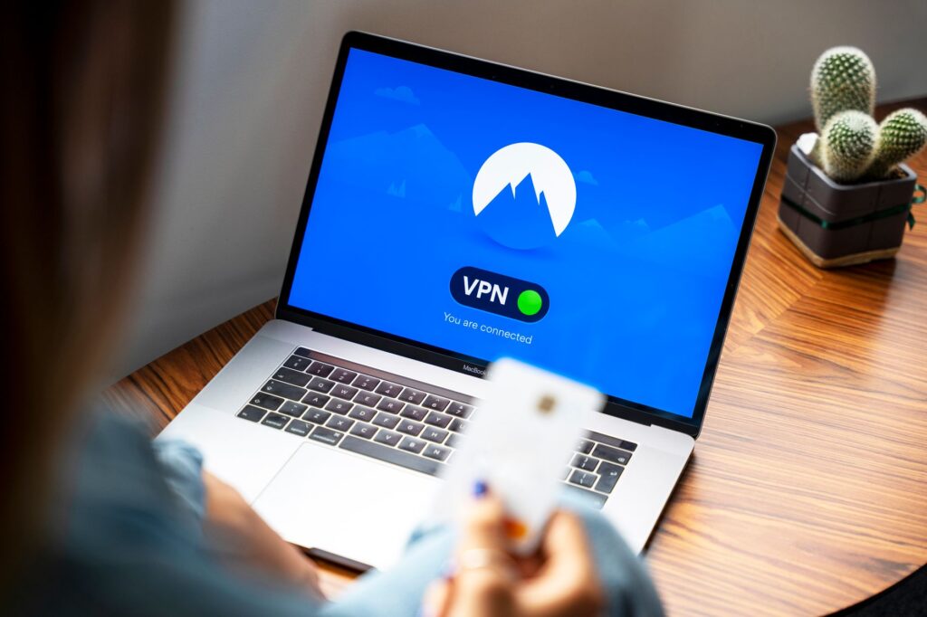 A person using a VPN on a laptop, representing secure and private internet browsing