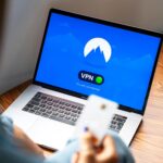 A person using a VPN on a laptop, representing secure and private internet browsing
